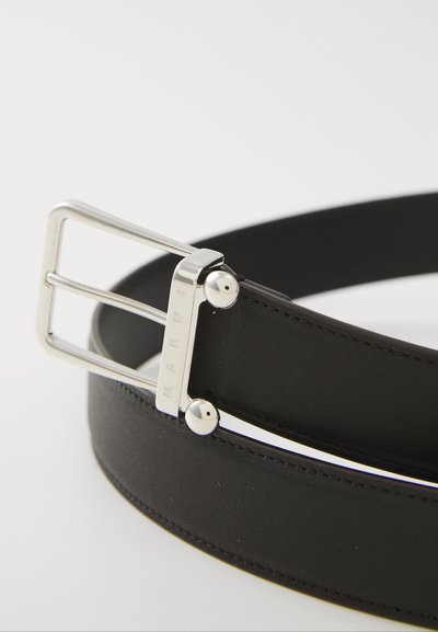Black leather belt featuring a silver rectangular buckle with engraved brand name and two metal accents. Smooth texture with neat stitching.