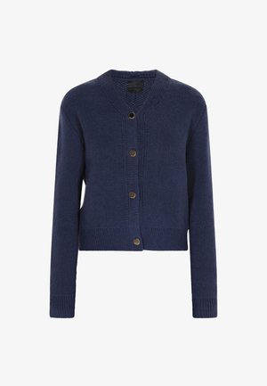 Tumesinine kootud kardigan, millel on nööbiga esiosa, V-kaelus ning soonikkoes mansetid ja serv. Omab nelja ümmargust, kuldset nööpi.