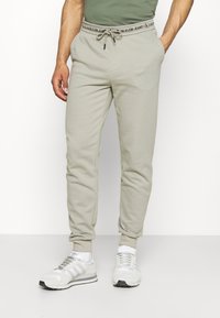 Calvin Klein Jeans Teplákové kalhoty - grey