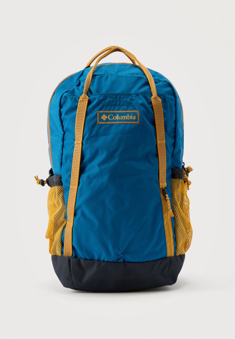 Sac à dos Columbia bleu et jaune avec poignées supérieures, fermeture éclair frontale, poches latérales en mesh et partie inférieure noire.