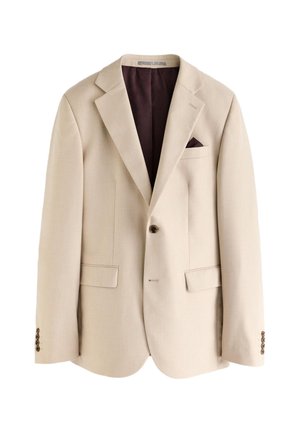 Blazer beige simple boutonnage avec revers crantés, un bouton, deux poches avant à rabat, une poche poitrine avec un mouchoir de poche marron foncé et une doublure marron foncé.