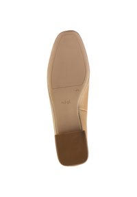 Beige leather shoe sole with a smooth texture, square heel, and a rubberized bottom for traction. Engraved brand name seen.
