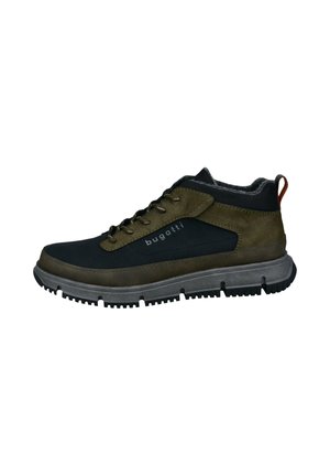 Men's ankle-height shoes in dark green and black synthetic material, featuring a textured rubber sole and visible lacing.