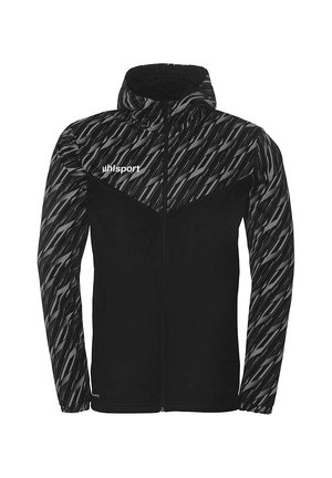 Schwarze Jacke mit einem Reißverschluss vorne, Kapuze und strukturiertem Muster in Grautönen an den Ärmeln und im oberen Bereich. Mit dem "uhlsport"-Logo auf der Brust.