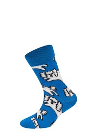 Lys blå sok med et legende mønster af hvide hunde med sorte konturer, vist fra en vinkel for at fremhæve designet.