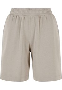 Shorts avec taille élastique beige clair, poches latérales, longueur mi-cuisse, et détails de couture simples.