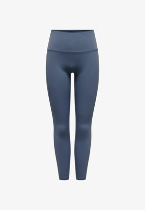 Höga leggings i en mörkblå färg, tillverkade av ett mjukt tyg med en stretchig passform, utan synliga mönster eller dekorationer.