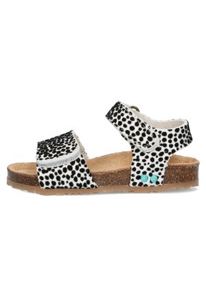 Schwarz-weiße Polka-Dot-Sandalen mit Korksohle, verstellbarem Riemen und hellblauen Akzenten an der Seite. Flaches Design, offene Zehen.