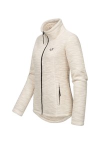 Veste en polaire beige clair avec un col haut, fermeture éclair noire et poches latérales. Tissu texturé avec des accents de couture noire contrastante.