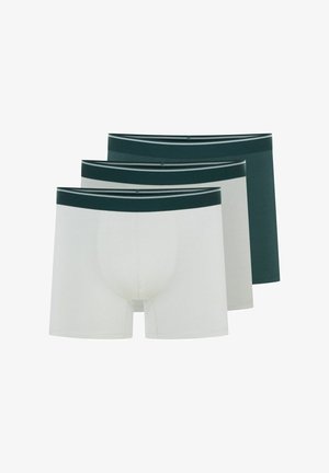 Ciemnozielone szorty bokserskie o dopasowanym kroju z kontrastowym paskiem w paski, noszone przez modela bez koszulki.