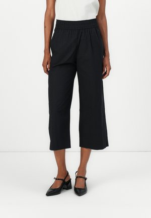 Black culotte pants with an elastic waistband, featuring a relaxed fit and cropped length, made from lightweight fabric.
