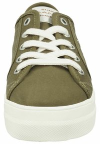 Olive green canvas sneaker with white laces, round eyelets, and a textured rubber sole, featuring a stitched toe cap and padded collar.