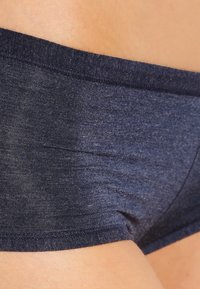 Navy blue cotton blend underwear with a smooth texture, mid-rise design, and elastic waistband. Features a simple, seamless construction.