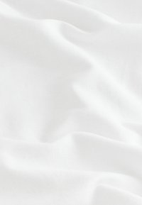 White linen fabric with a soft, textured surface, featuring slight waves and folds, evenly lit with no visible patterns or embellishments.