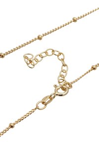 Gold chain necklace with twisted links and round accents. Features a secure lobster clasp and adjustable length with additional links.