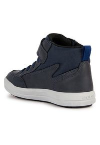 Sneaker alte blu scure con tomaia in pelle liscia e tessuto testurizzato, suola in gomma bianca, cinturino regolabile e dettagli blu.