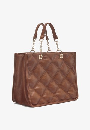 Brown quilted leather handbag with dual chain-linked handles and gold ring accents, standing upright on a white background.
