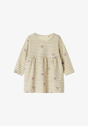 Vestido de manga larga a rayas en crema con líneas oscuras y corazones rosa claro dispersos. Cuenta con una cintura fruncida y un escote redondo.