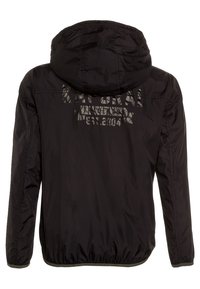 Black hooded jacket featuring a smooth, lightweight fabric, elastic cuffs, and a reflective logo print on the back.