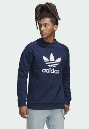 Sudadera azul marino con el logo blanco de Adidas y tres rayas. Fabricada en un suave tejido con puños y dobladillo acanalados, presenta un diseño de cuello redondo.