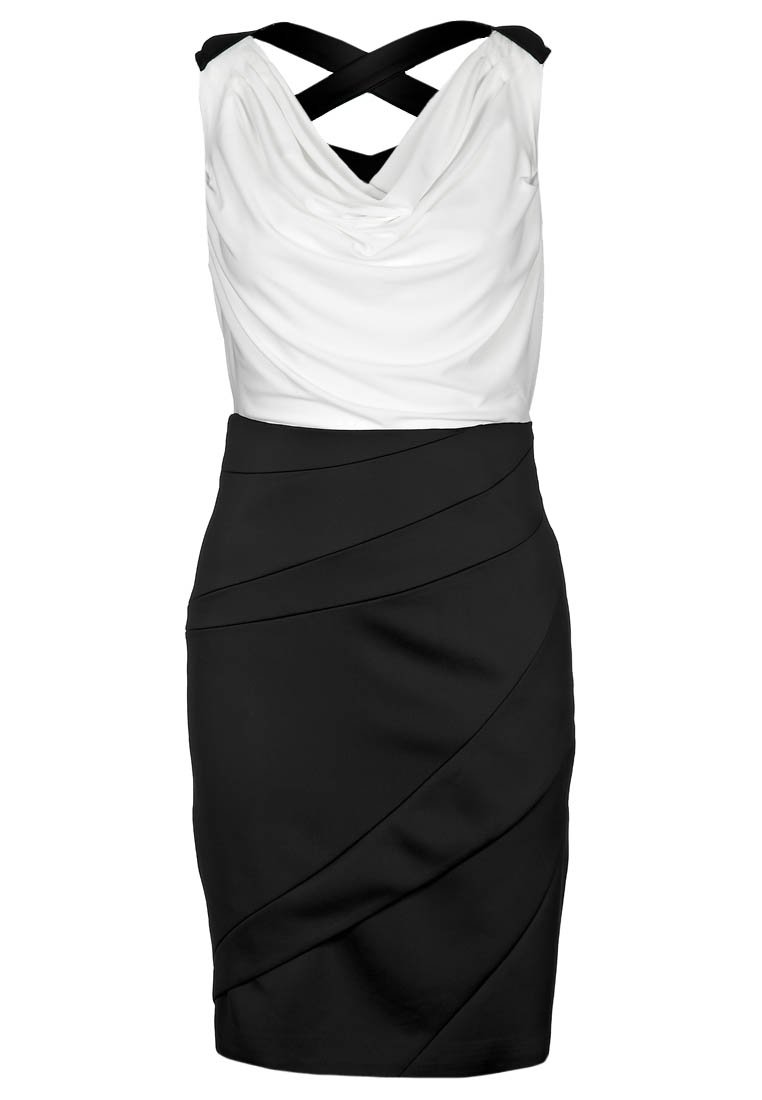 Svart och vit ärmlös klänning med en draperad vit topp, figurnära svart kjol med diagonala veck och korsade band.