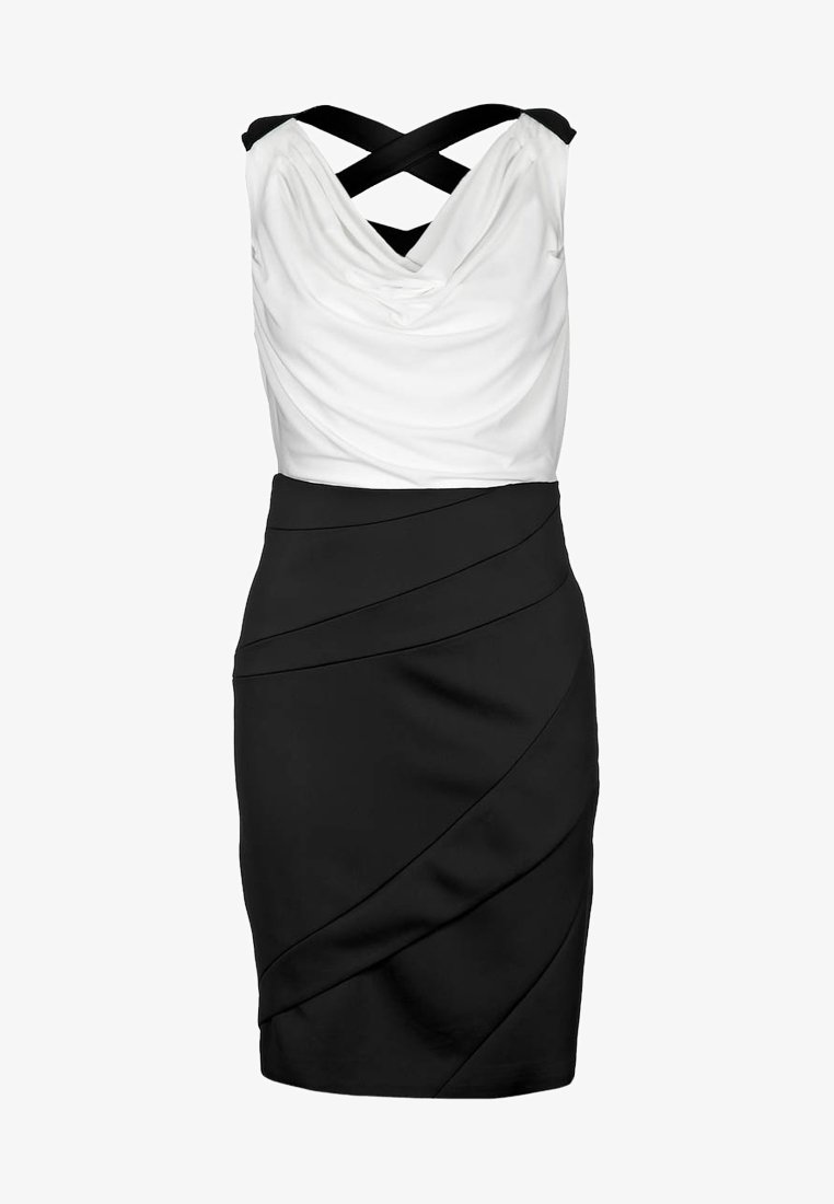 Svart och vit ärmlös klänning med en draperad vit topp, figurnära svart kjol med diagonala veck och korsade band.