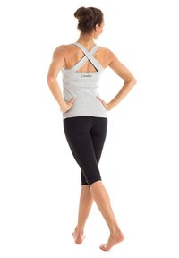 Light gray tank top with a crisscross back design, paired with black capri leggings. Fabric appears soft and stretchy. Subtle logo detail on top.