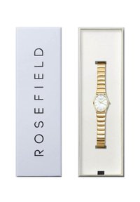 Zlatni sat s segmentiranim metalnim remenom, bijelim brojčanikom i minimalističkim oznakama sati, prikazan u bijeloj kutiji s logotipom "ROSEFIELD".