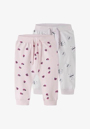 Two pairs of toddler pants, one light pink with pink ladybug prints, one white with black and white butterfly prints, both with drawstring waistbands.