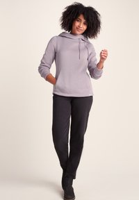 Lavender pullover hoodie with a drawstring neckline, pockets, and ribbed cuffs. Paired with black, slim-fit pants and black boots.