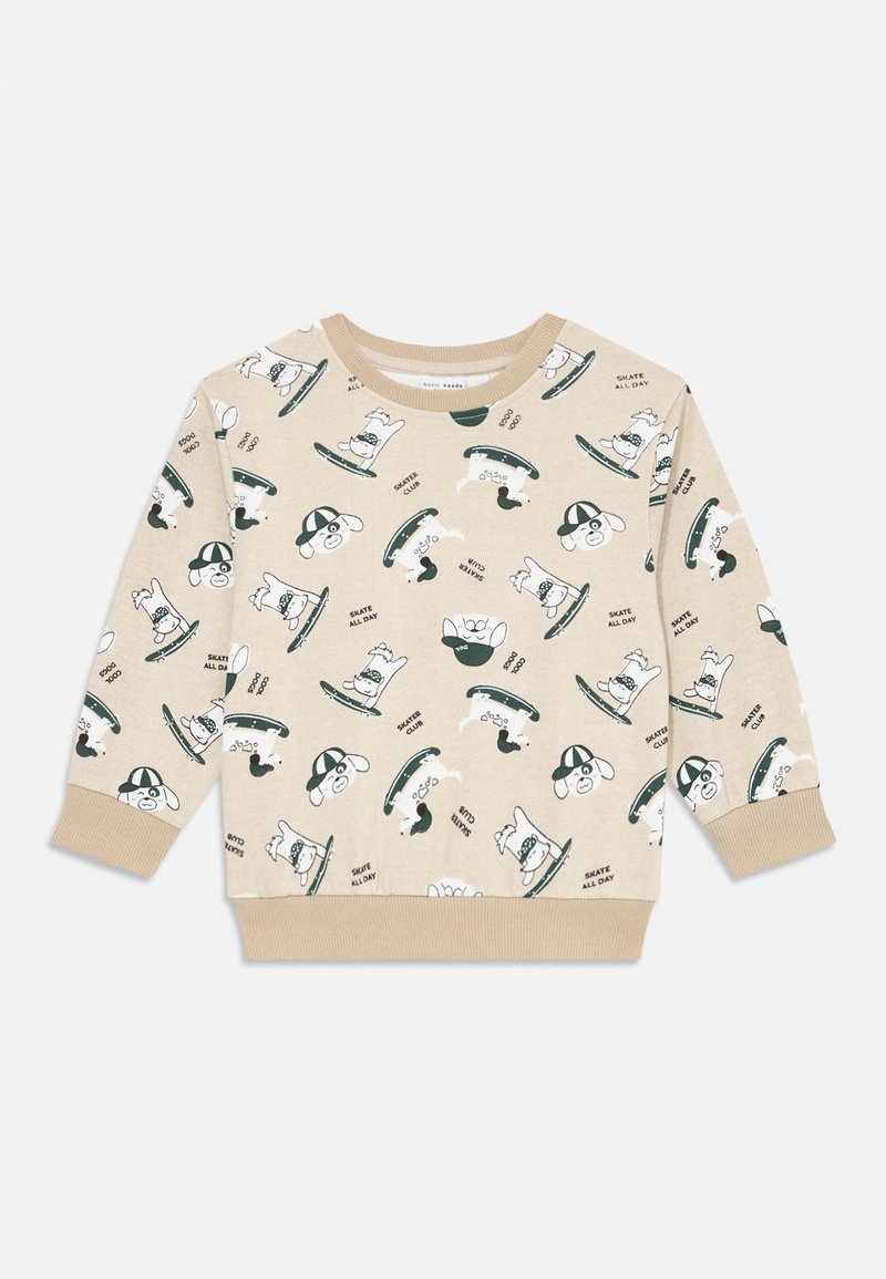 Beige collegepaita, jossa on leikkisä printti koirista skeittilaudoilla. Pitkät hihat, pyöreä pääntie, ribbatut hihansuut ja helma.