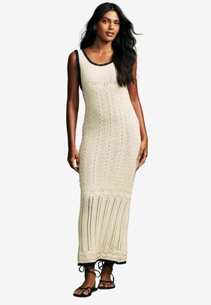 Strick-Maxi-Kleid in Creme mit Blättermustern, marineblauen Akzenten am Ausschnitt und Saum. Verfügt über eine figurbetonte Silhouette und ein Lochmuster-Design.