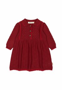 Punane kudum dress krae, kolme nupuga esikülg ja pikad varrukad. Omab teemantmotiive ja lainelisi ääriseid hemmi ja mansettide ääres.