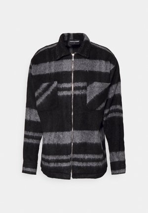 Black and gray striped zip-up jacket with collar and chest pockets, made from textured fabric.