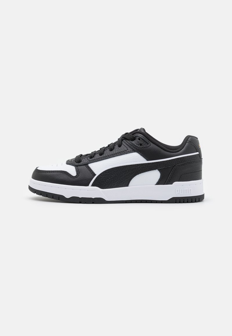 Black and white sneaker with a leather upper, textured accents, padded tongue, lace-up design, and a rubber outsole featuring grooves.