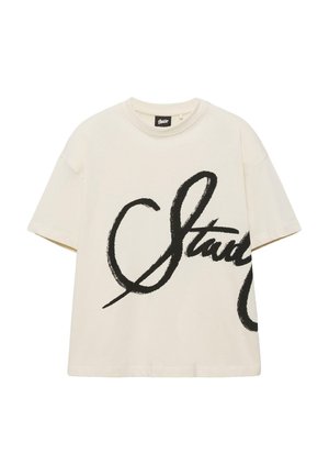 Kurzärmeliges T-Shirt in Cremefarbe mit übergroßem, schwarzem Kursivschriftzug auf der Vorderseite und rundem Ausschnitt.