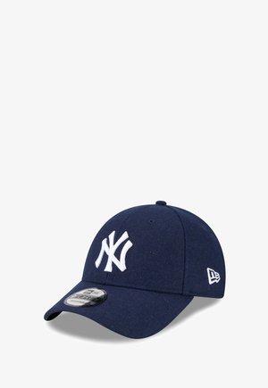Navy blue baseball cap made of textured wool, featuring a white embroidered "NY" logo on the front and a small white logo on the side.