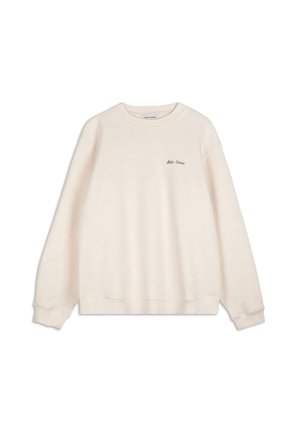 Light beige sweatshirt made of soft, textured fabric. Features a classic crew neck and long sleeves, with small black embroidered logo on chest.