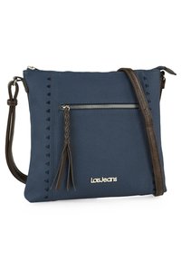 Bolso cruzado azul marino con una tela texturizada, que cuenta con un bolsillo frontal con cremallera, detalle de borlas trenzadas y una correa marrón. Logo exhibido.