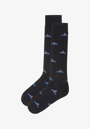 Black cotton socks featuring a repeating pattern of blue cars with a dog in the driver's seat. Soft texture, standard crew length.