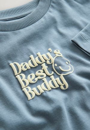 Light blue cotton sweatshirt featuring textured cream lettering that reads "Daddy's Best Buddy," with a smiley face detail.