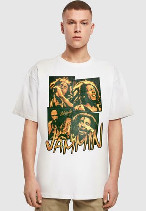 White oversized T-shirt featuring a graphic print of four images, including musicians and the word "JAMMIN" in bold orange text.