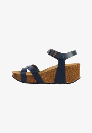 Navy leather wedge sandals with cork midsole and black rubber outsole. Features crisscross straps and an adjustable ankle buckle.