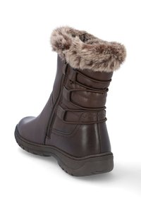 Las botas de tobillo de cuero marrón tienen un puño de piel sintética, cierre de cremallera lateral y acentos horizontales en el eje. Suela de goma gruesa para mayor tracción.