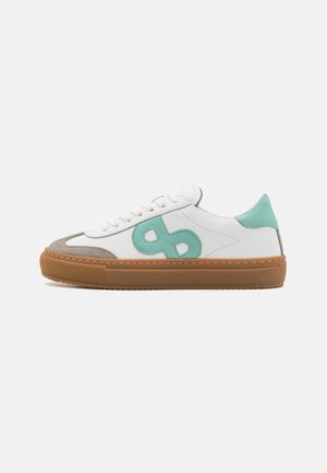 White sneakers with mint green accents, suede toe cap, and light brown rubber sole; flat laces and side logo detail.