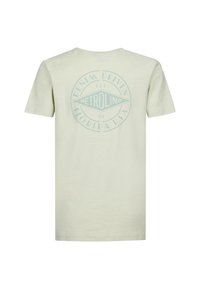Jasno beżowa bawełniana koszulka z krótkimi rękawami, z dużym niebieskim okrągłym logo na plecach, na którym widnieje napis „PETROLIND” i „DENIM DRIVEN.”