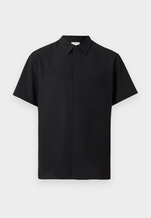 Chemise noire à manches courtes avec col et une seule poche poitrine, affichée sur un fond clair uni.