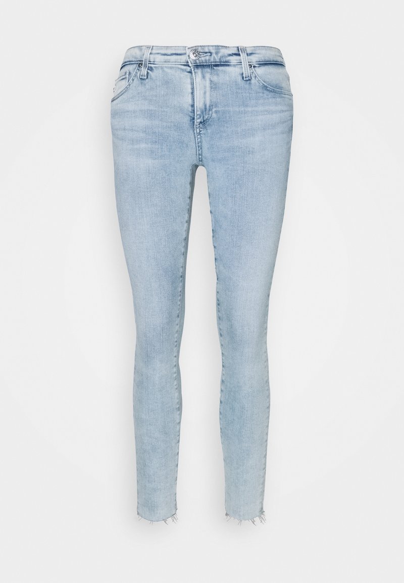 Světle modré skinny džínové kalhoty s roztrhaným lemem, pětikloubkovým designem a klasickým zipem s knoflíkovým uzávěrem.