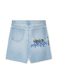 Light blue denim shorts with a straight cut, featuring two back pockets and graffiti-style text in black and blue on the left side.