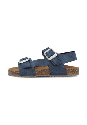 Sandalias de tela azul con dos correas ajustables, plantilla de corcho y suela de goma texturizada. Diseño minimalista, punta abierta y talón.